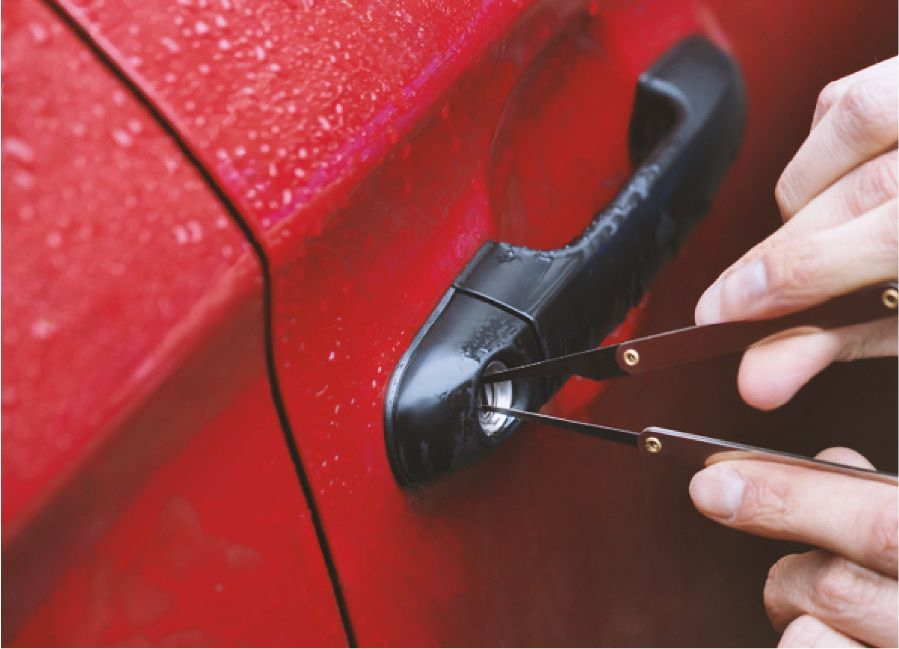 A Technician Is Opening A Car Door Lock With A Pair Of Picks.