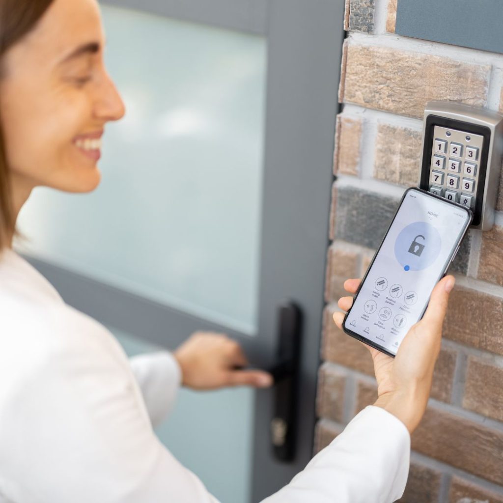 A Woman Is Using A Smartphone To Open A Door.